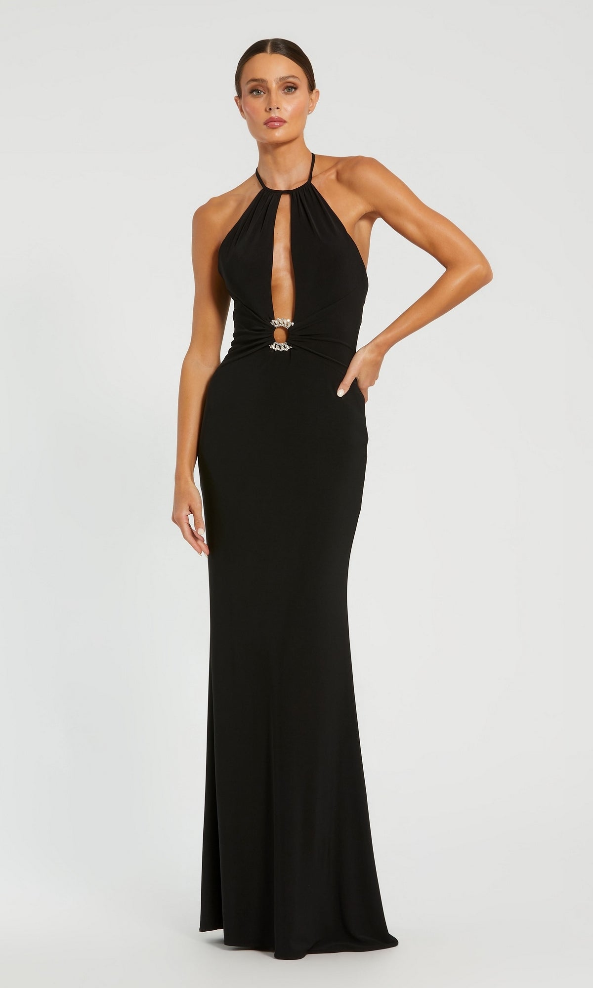 A woman poses gracefully in the Backless High-Neck Long Black Formal Dress 42065, a sleeveless floor-length black gown featuring a keyhole front cutout, set against a plain white background.